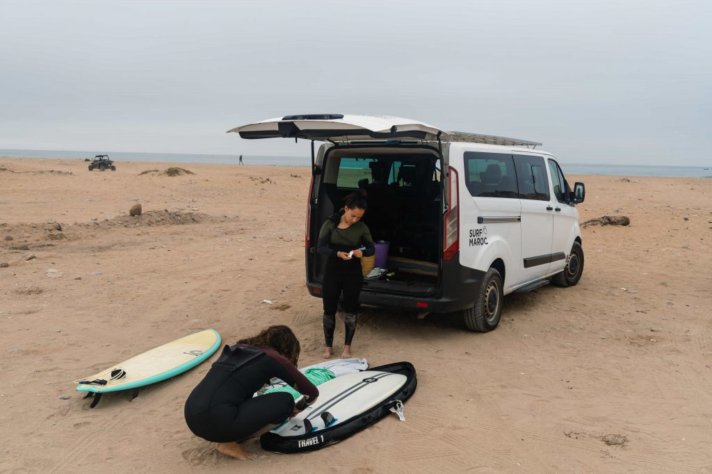 Two girls getting ready for a surf in Morocco
