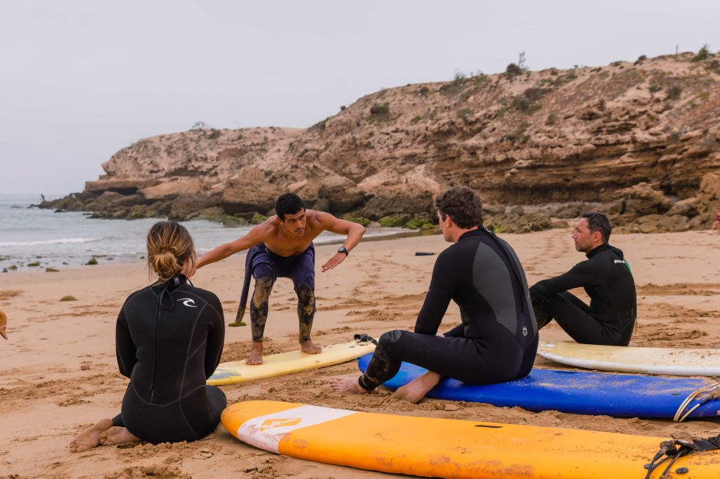 Group of beginner surfers taking a surf lesson