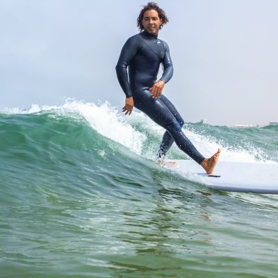 Surf instructor riding waves